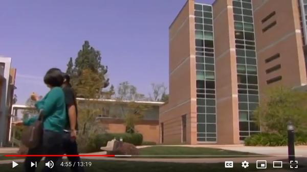 students walking past a building (c) UCR